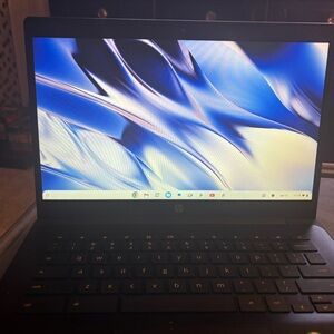 Black HP Chromebook Laptop computer with charger.